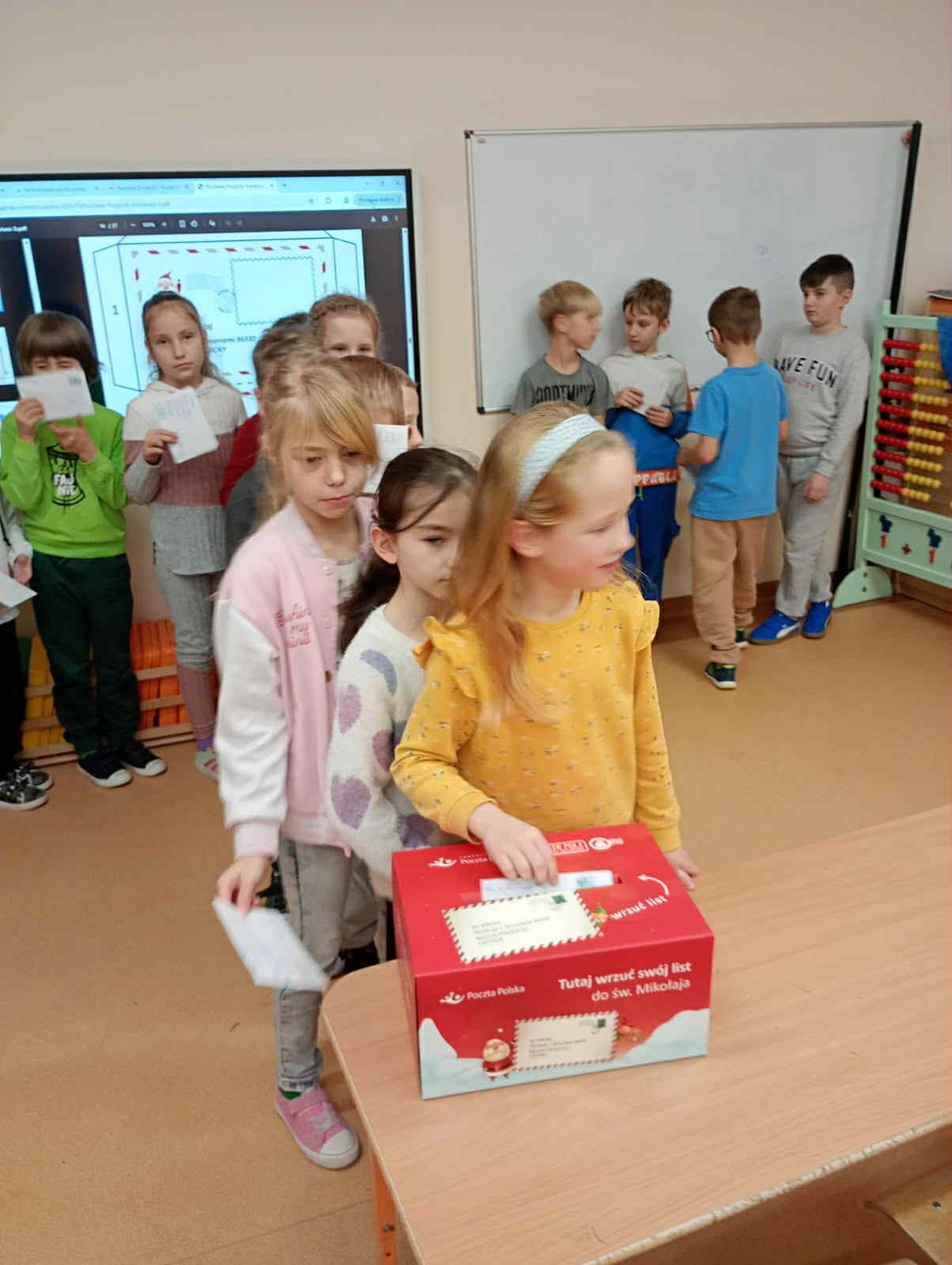 Dzieci wrzucające listy do skrzynki